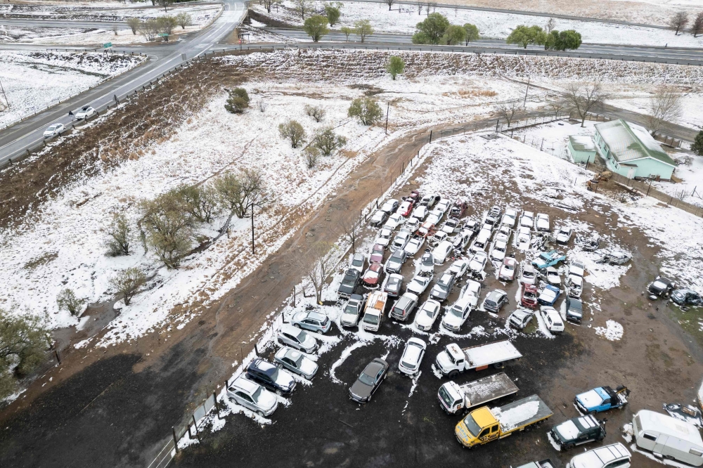 snow covering old cars in the town of Warden