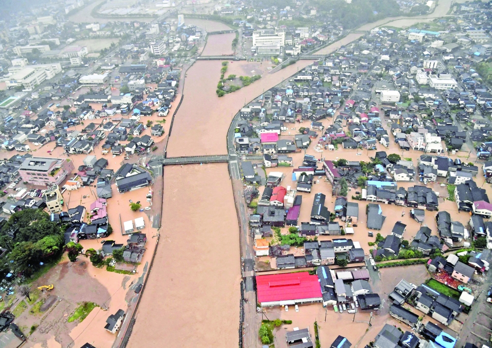 An aerial view shows a flooded residential area caused by torrential rain in Wajima, Japan. — Reuters