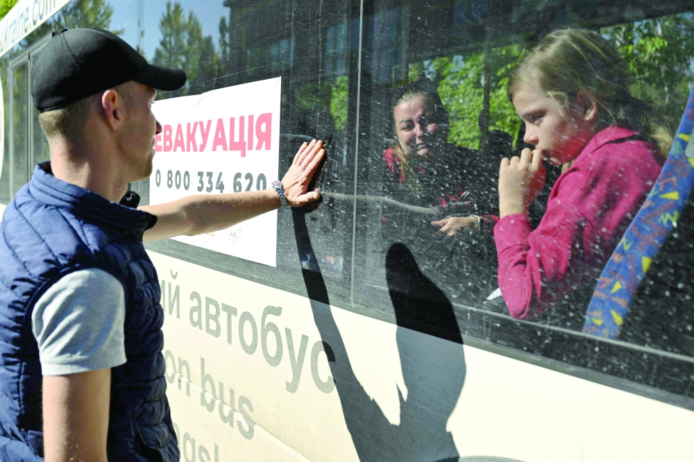 A man reacts when his wife and daughter departure aboard of an evacuation bus in the city of Pokrovsk, Donetsk region. — AFP