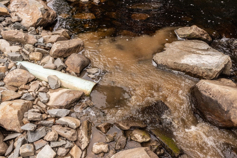 A liming machine built by salmon conservationists in 2016 sends a slurry of limestone and water into the Killag River near Sheet Harbour, Nova Scotia, Canada, Aug. 26, 2024. (Greta Rybus/The New York Times)
