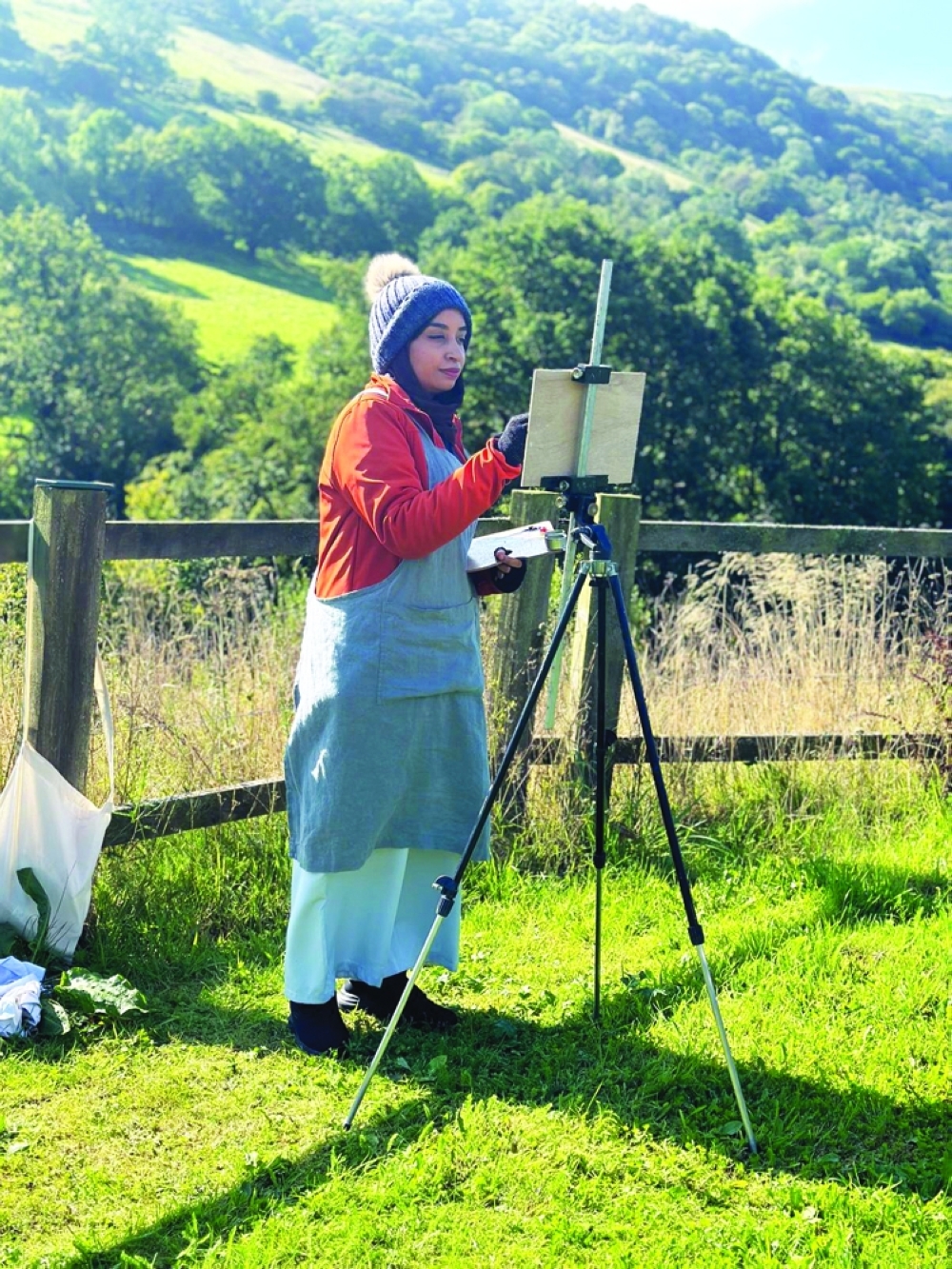 Sara al Hosni painting the landscape in Wales.