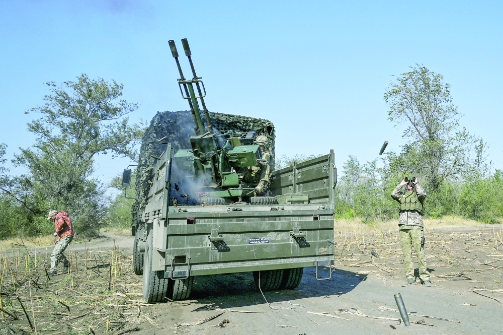 Ukrainian servicemen fire ZU-23-2  anti-aircraft cannon near a frontline, in Zaporizhzhia region, Ukraine. — Reuters 
