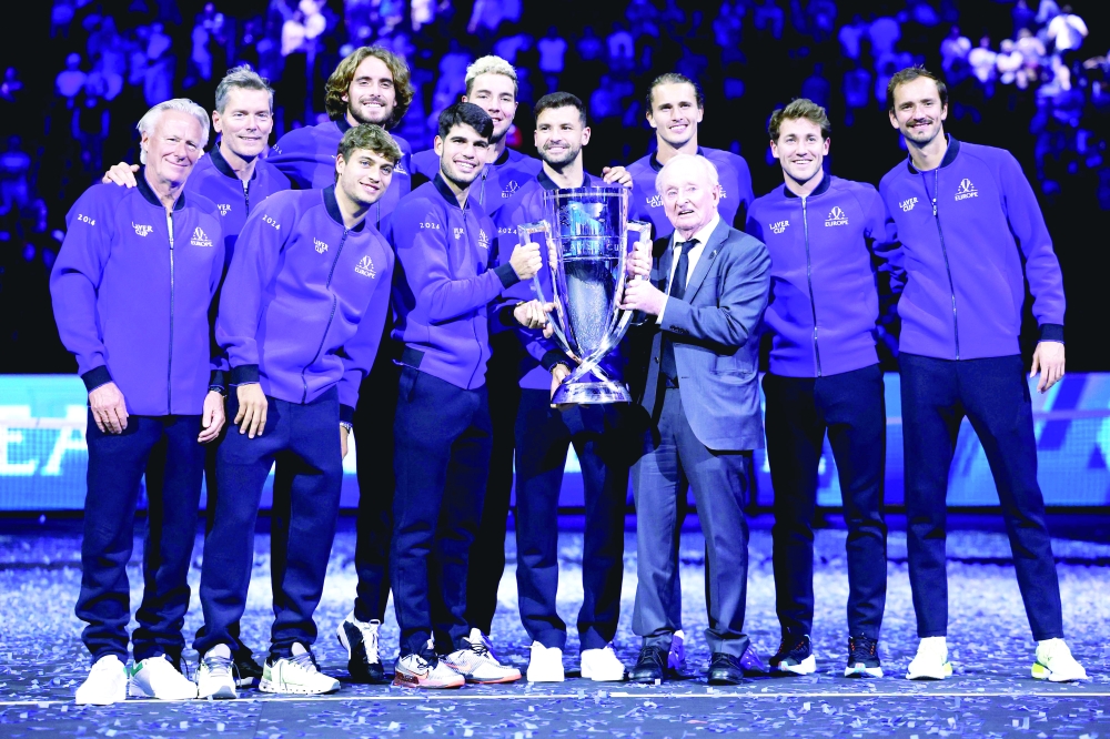 Australian former tennis player Rod Laver (3R) holds the trophy as he poses with Team Europe's captain Bjorn Borg (L), Greece's Stefanos Tsitsipas (4L), Spain's Carlos Alcaraz (5L), Bulgaria's Grigor Dimitrov (5R), Germany's Alexander Zverev (4R), Russia's Daniil Medvedev (R) and other players of Team Europe during the awarding ceremony at the end of the 2024 Laver Cup tennis tournament in Berlin, Germany on September 22, 2024. Spain's Carlos Alcaraz won the last match of the tournament 6-2, 7-5 against USA's Taylor Fritz of Team World. Team Europe won 13-11 against Team World. 