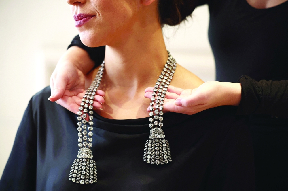 A gallery assistant poses wearing an 18th century diamond jewel necklace weighing approximately 300 carats at a press preview at Sotheby's in London on September 23, 2024. This necklace (is estimated to fetch £1,350,000 - £2,100,000 GBP, 1,620,000 - 2,500,000 Euro, $1,800,000 – $2,800,000 USD) and will be the highlight of Sotheby’s jewellery sales and auctioned as part of the Royal and Noble sale taking place in Geneva on November 11 ahead of the Magnificent Jewels sale on 13 November.