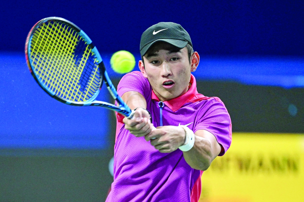 China's Shang Juncheng hits a return against Germany's Yannick Hanfmann during their men's singles semifinal match at the ATP Chengdu Open tennis tournament in Chengdu, in China's southwestern Sichuan province on September 23, 2024.