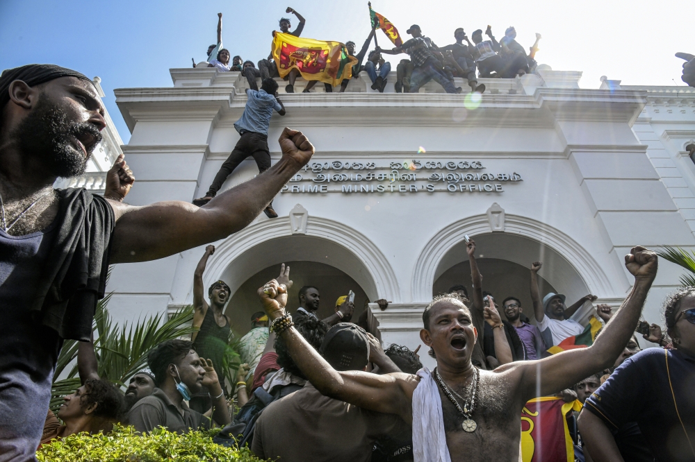Protesters celebrate after taking control of the prime ministers office in Colombo, Sri Lanka, on July 13, 2022. A wave of discontent crested in 2022 with a popular uprising over an economic collapse. (Atul Loke for The New York Times)