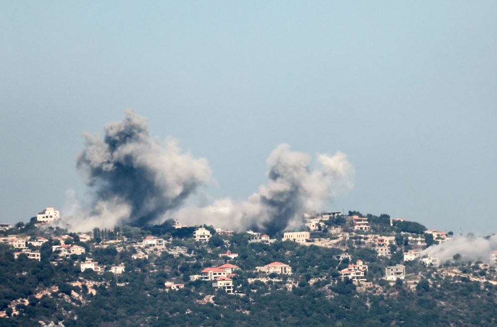 Smoke billows over southern Lebanon, amid ongoing cross-border hostilities between Hezbollah and Israeli forces, as seen from Marjayoun, near the border with Israel, September 25, 2024. 