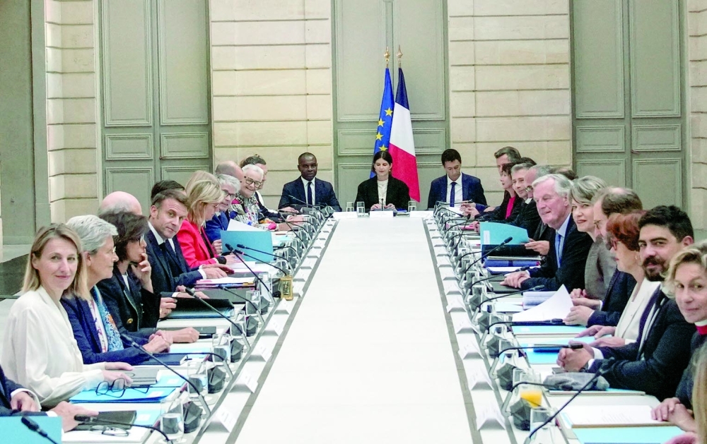 French President Emmanuel Macron and Prime Minister Michel Barnier meet with members of the new government during the weekly cabinet meeting at the Elysee Palace in Paris. - Reuters