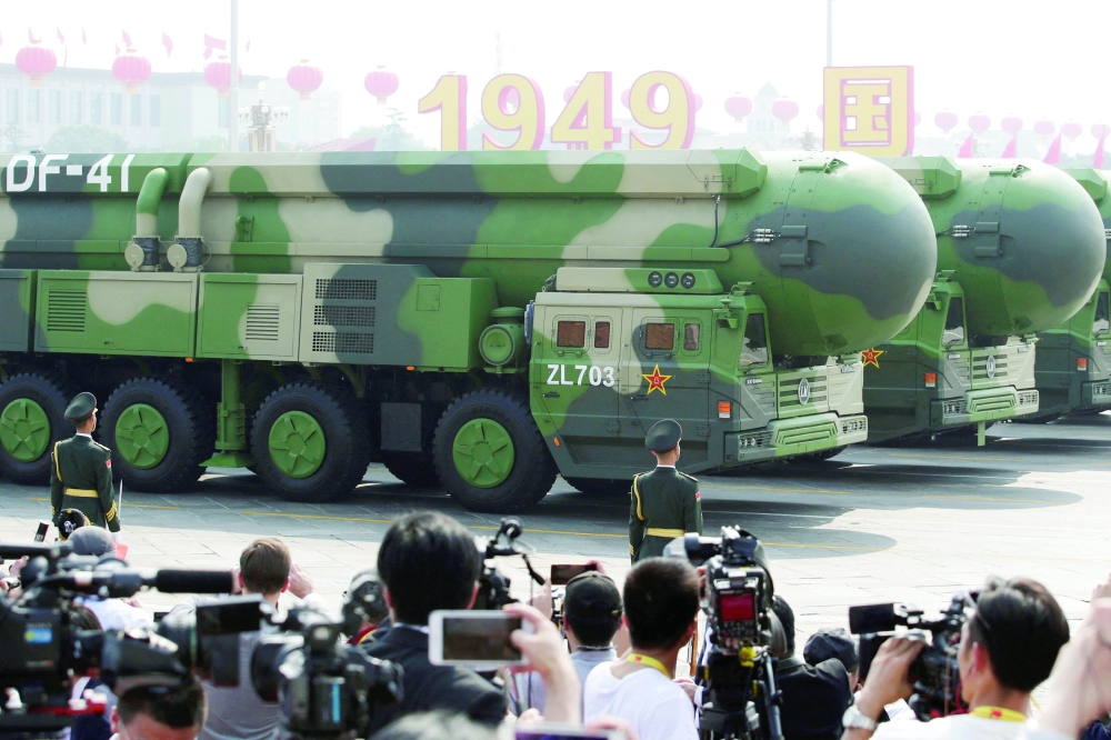 Military vehicles carrying intercontinental ballistic missiles travel past Tiananmen Square during the military parade marking the 70th founding anniversary of China on its National Day in Beijing. — Reuters File