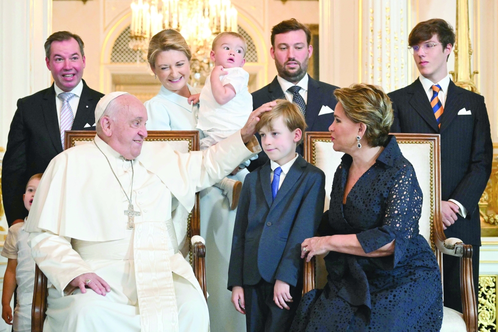 Pope Francis poses with Grand Duchess Maria Teresa of Luxembourg and others at the Grand ducal palace in Luxembourg, during a four-day apostolic journey in Luxembourg and Belgium. - AFP

