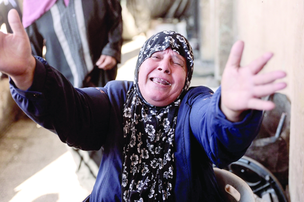 A woman reacts following an Israeli strike on a school sheltering displaced Palestinians in Falluja near the Jabalia refugee camp in the norther Gaza Strip. - AFP


