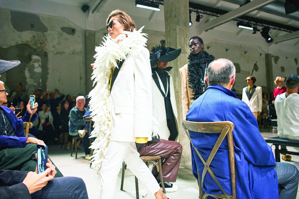 Models present looks at the Marni spring 2025 fashion show in Milan, Sept. 17, 2024. 