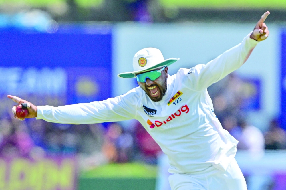 Sri Lanka's Dinesh Chandimal celebrates after taking a catch to dismiss New Zealand's Devon Conway. — AFP