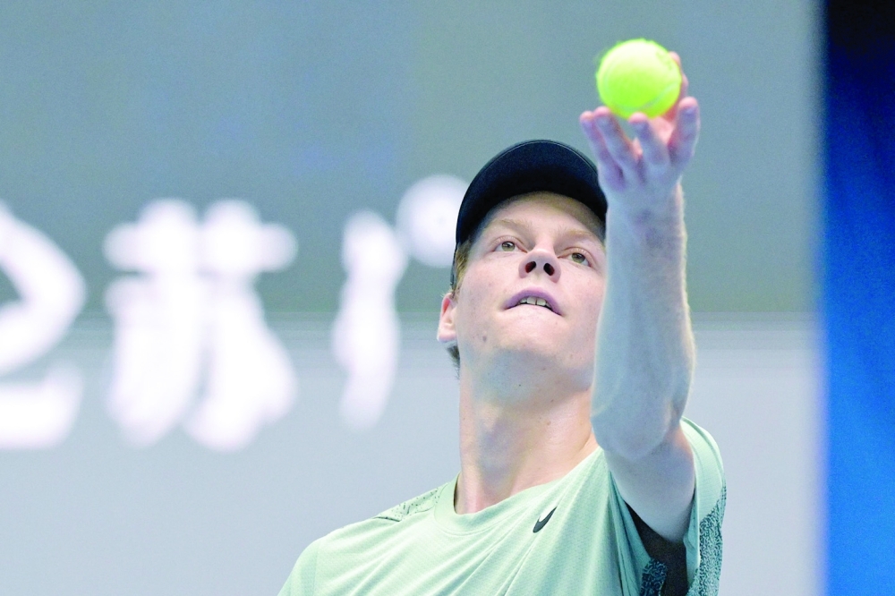 Italy Jannik Sinner serves the ball to Russia Roman Safiullin during their men's singles match at the China Open tournament in Beijing on September 28, 2024.