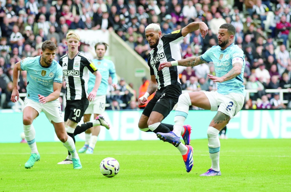 Manchester City's Kyle Walker in action with Newcastle United's Joelinton. — Reuters