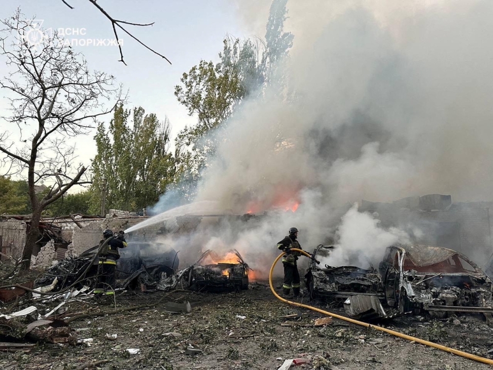 Firefighters work at a residential area hit by a Russian air strike, amid Russia's attack on Ukraine, in Zaporizhzhia, Ukraine. — Reuters