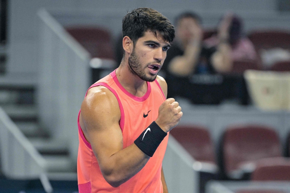 Spain's Carlos Alcaraz reacts during the men's singles match against Netherlands's Tallon Griekspoor at the China Open tennis tournament in Beijing on September 29, 2024. (Photo by Jade Gao / AFP)

