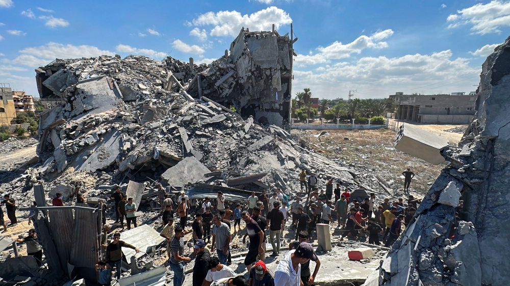 Palestinians gather at the site of an Israeli strike on a residential building, in Nuseirat in the central Gaza Strip. — Reuters 