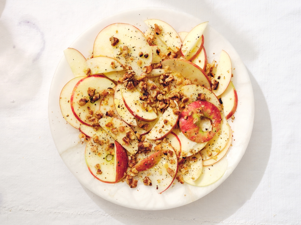 Apples with honey and crushed walnuts. Props styled by Kalen Kaminski. (Michael Graydon & Nikole Herriott/The New York Times)