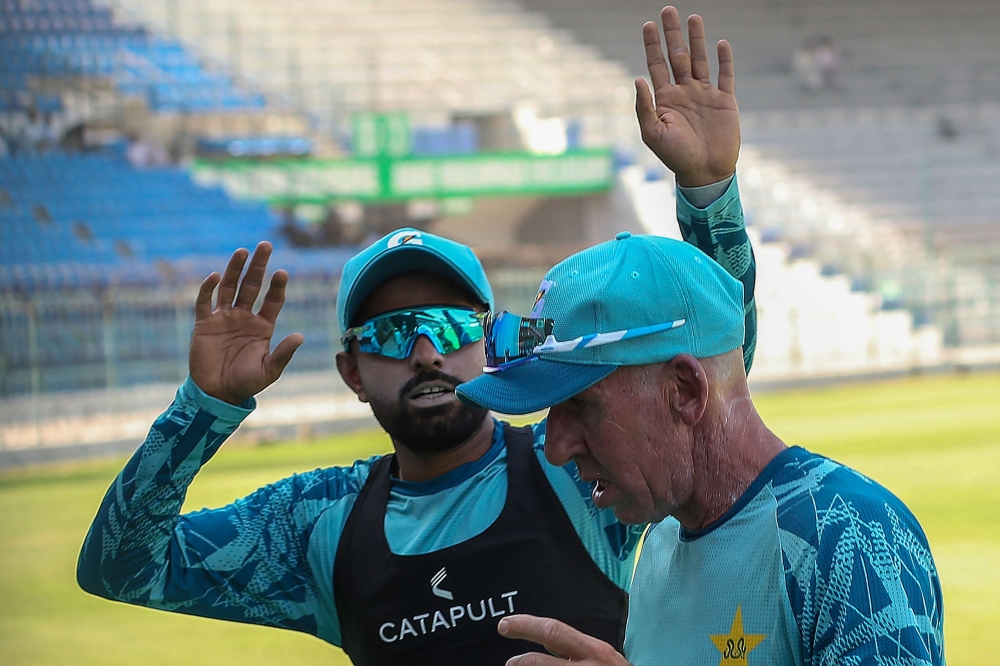 Pakistan's cricketer Babar Azam (L) gestures at the Multan Cricket Stadium in Multan on October 2, 2024.  Babar Azam resigned as Pakistan's white-ball skipper on October 1, saying he wanted to focus on his playing role in the future matches, batter said on social media site X. (Photo by Shahid Saeed MIRZA / AFP)

