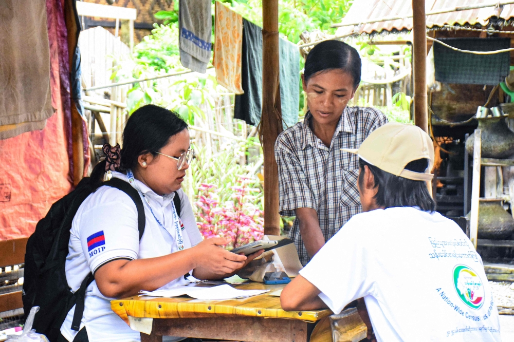Census enumerators collect information during a national census in Naypyidaw. — AFP 