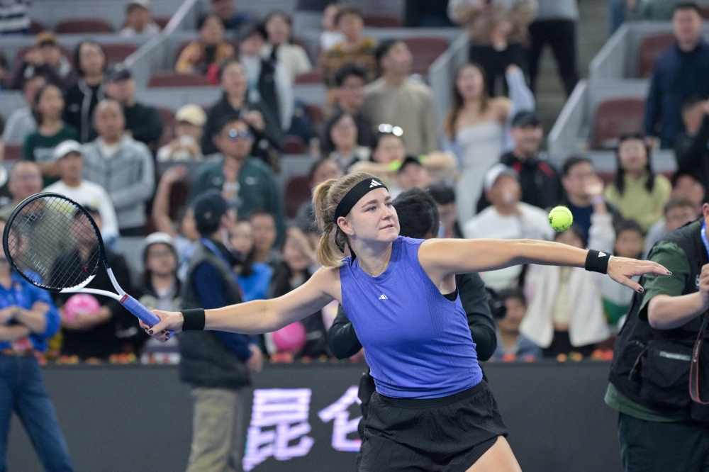 Czech Republic痴 Karolina Muchova serves balls to spectators after winning the women's singles quarterfinal match against Belarus's Aryna Sabalenka 
