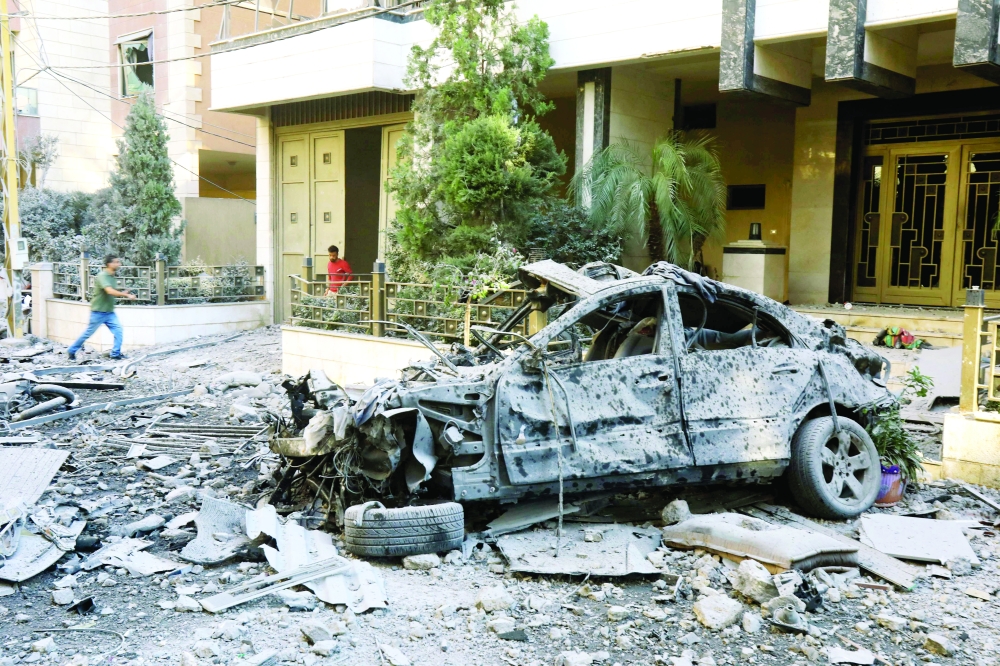 Residents check the destruction in the aftermath of an Israeli strike on the neighbourhood of Mreijeh in Beirut's southern suburbs. - AFP 