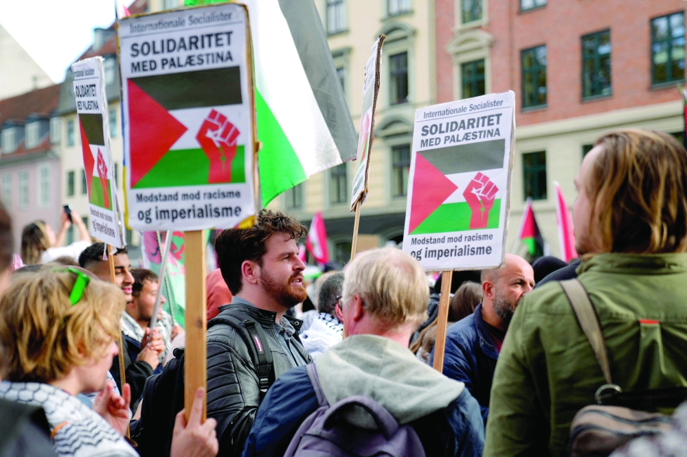 Participants march with placards during a pro-Palestinian demonstration in Copenhagen, Denmark. — AFP