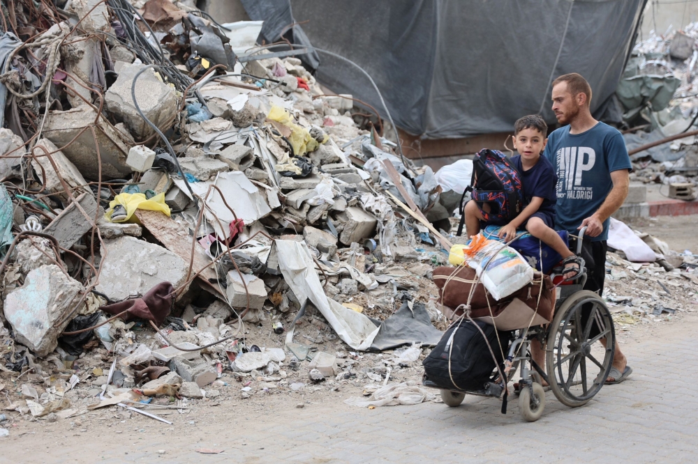 A Palestinian family arrives in Gaza City after evacuating their homes in the Jabalia area. — AFP 