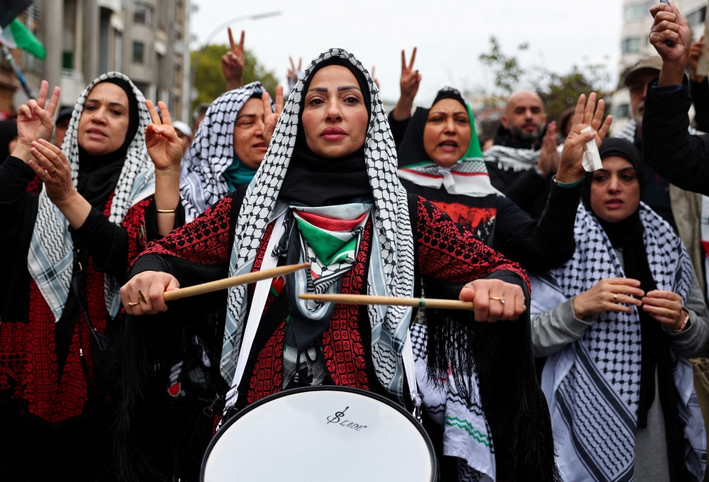 A protester plays a drum during a demonstration in support of Palestinians in Gaza, in Berlin. — Reuters 