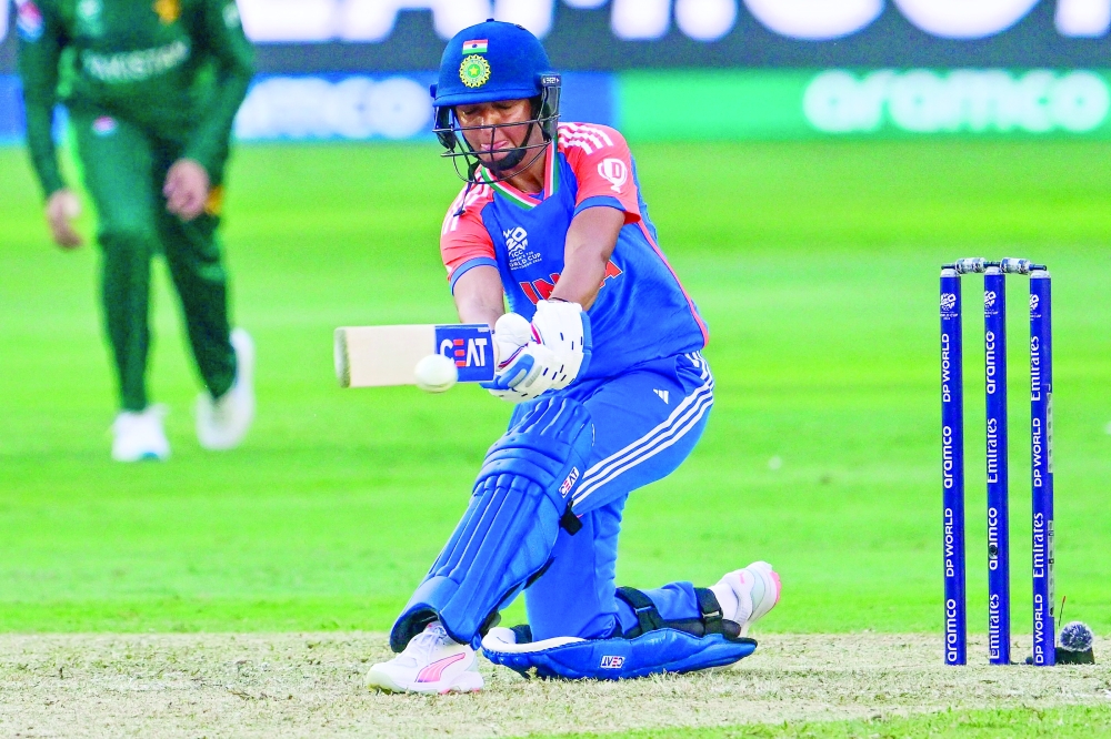 India's captain Harmanpreet Kaur plays a shot during the ICC Women's T20 World Cup cricket match between Pakistan and India at the Dubai International Cricket Stadium in Dubai on October 6, 2024.