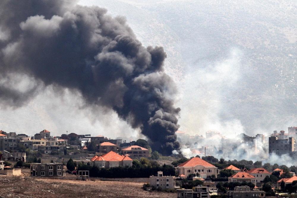  A plume of smoke billows following an Israeli air strike on the village of Khiam in southern Lebanon near the border. — AFP 