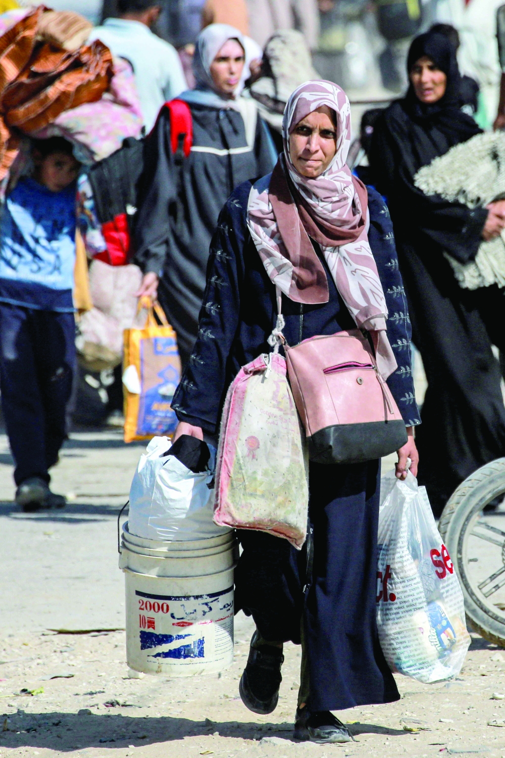 Displaced people arrive in Khan Yunis after being given notice by Israeli forces to evacuate from the eastern parts of the city in the southern Gaza Strip on Monday. —AFP