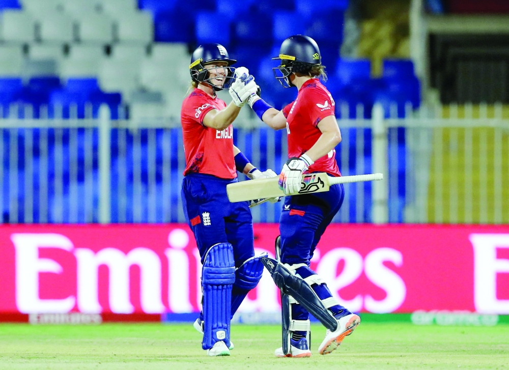 England's Nat Sciver-Brunt and Heather Knight celebrate after winning the match. — REUTERS