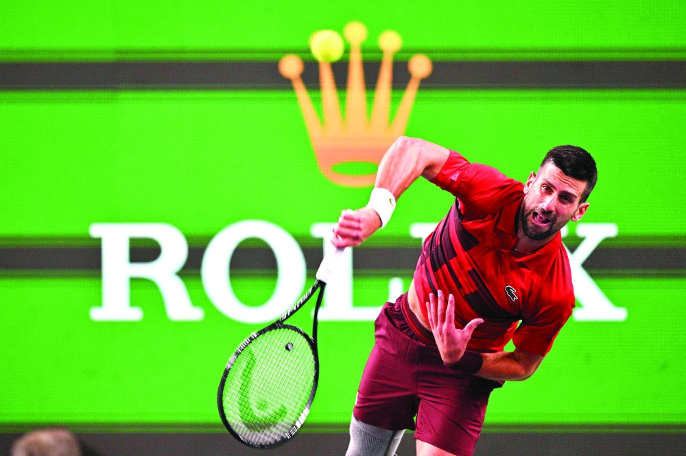 Serbia's Novak Djokovic serves against Italy's Flavio Cobolli during their men's singles match at the Shanghai Masters tennis tournament in Shanghai on October 8, 2024.