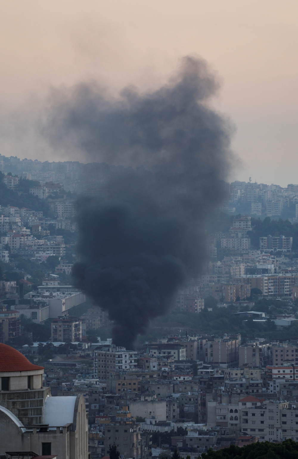 Smoke rises in Beirut's southern suburbs after a strike, amid the ongoing hostilities between Hezbollah and Israeli forces, as seen from Hadath, Lebanon, October 8, 2024. REUTERS/Mohamed Azakir