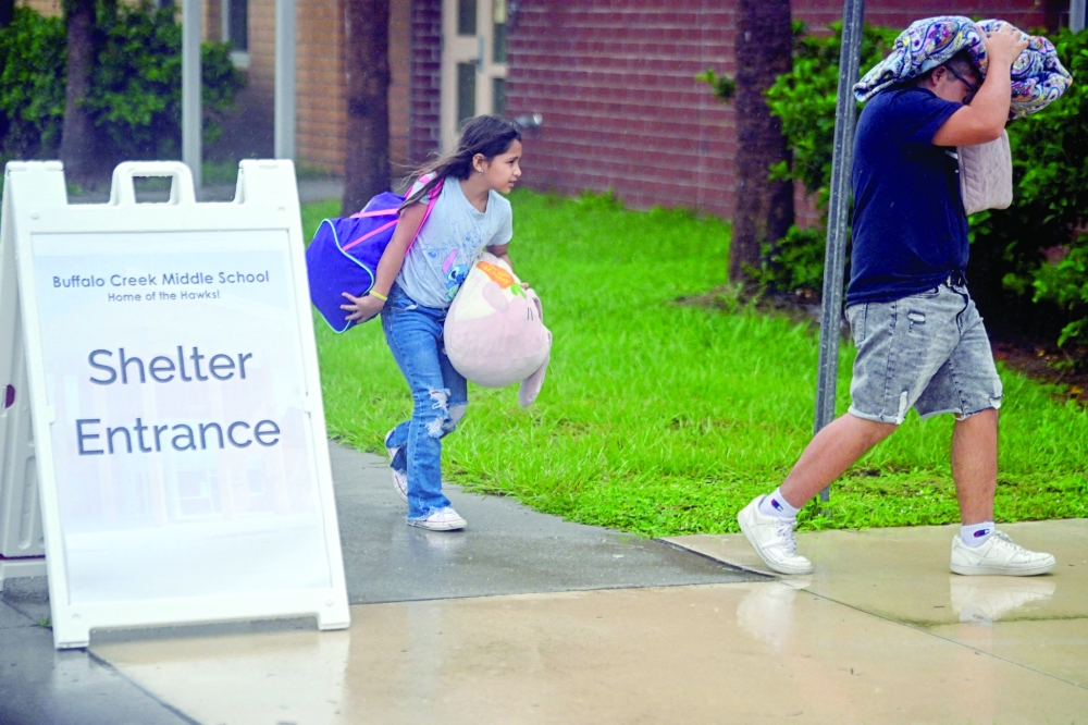 People arrive to shelter buffalo creek middle school ahead of Hurricane Milton expected landfall, in Florida. — AFP 