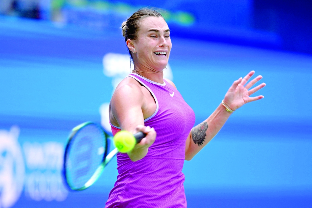 Belarus's Aryna Sabalenka hits a return to Czech Republic's Katerina Siniakova during their women's singles match at the Wuhan Open tennis tournament in Wuhan, China's Hubei province on October 9, 2024.