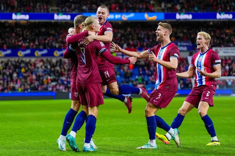 Norway's Erling Braut Haaland celebrates scoring their first goal with team-mates Fredrik Varfjell/NTB via REUTERS