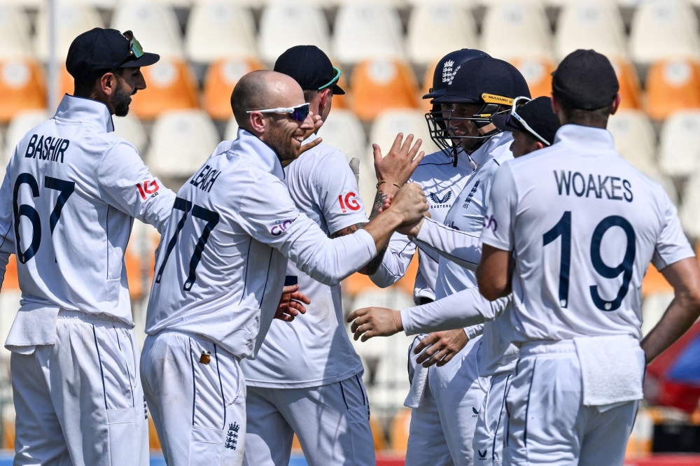 England's players celebrate after winning the first Test cricket match between Pakistan and England 