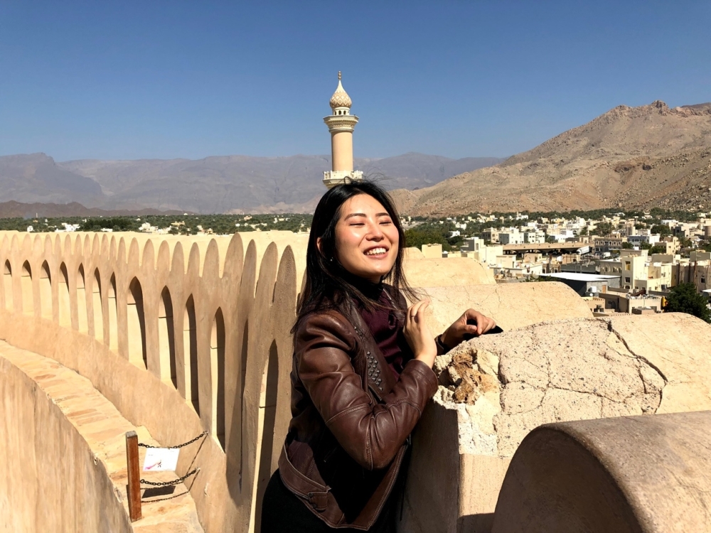 Hyeji Kim poses at the majestic Nizwa Fort