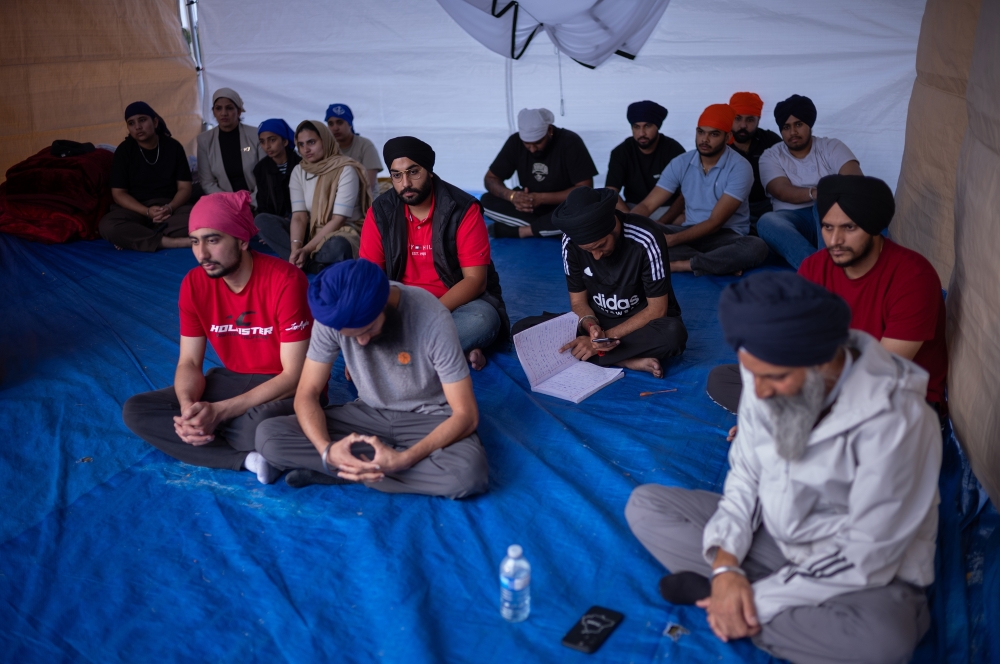 Evening prayers held at the Post-Graduate Work Permit activist encampment, in Brampton, Canada, Friday, Sept. 20, 2024. (Ian Willms/The New York Times)