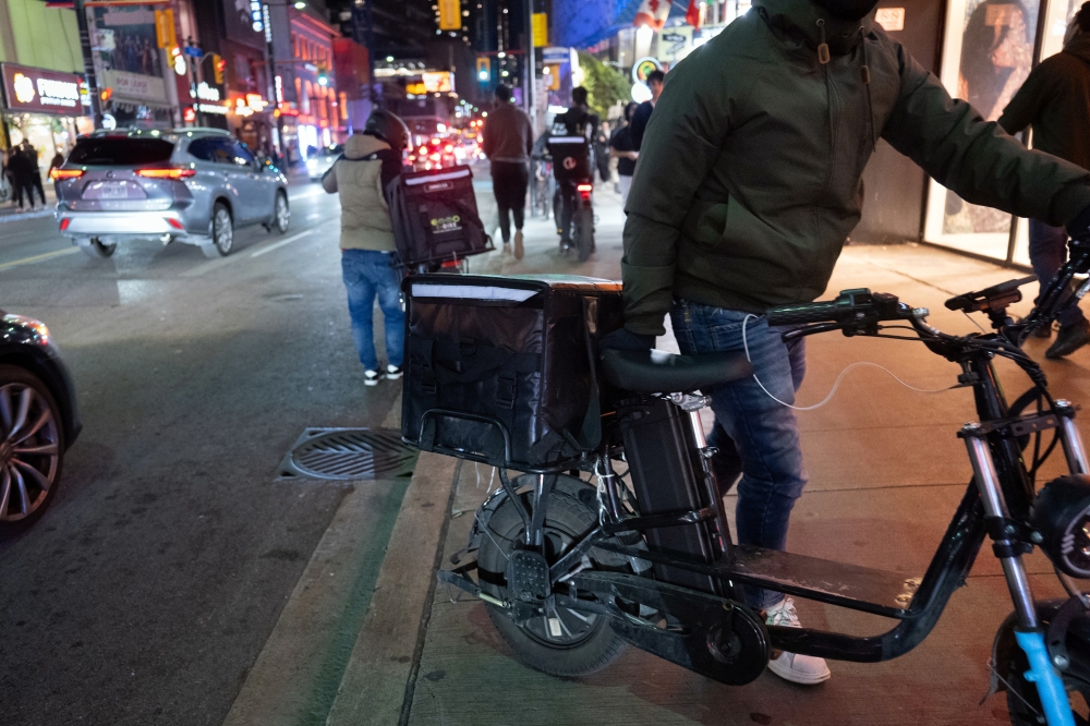 Bicycle delivery couriers, in Toronto, Canada, Friday, Sept. 20, 2024. (Ian Willms/The New York Times)