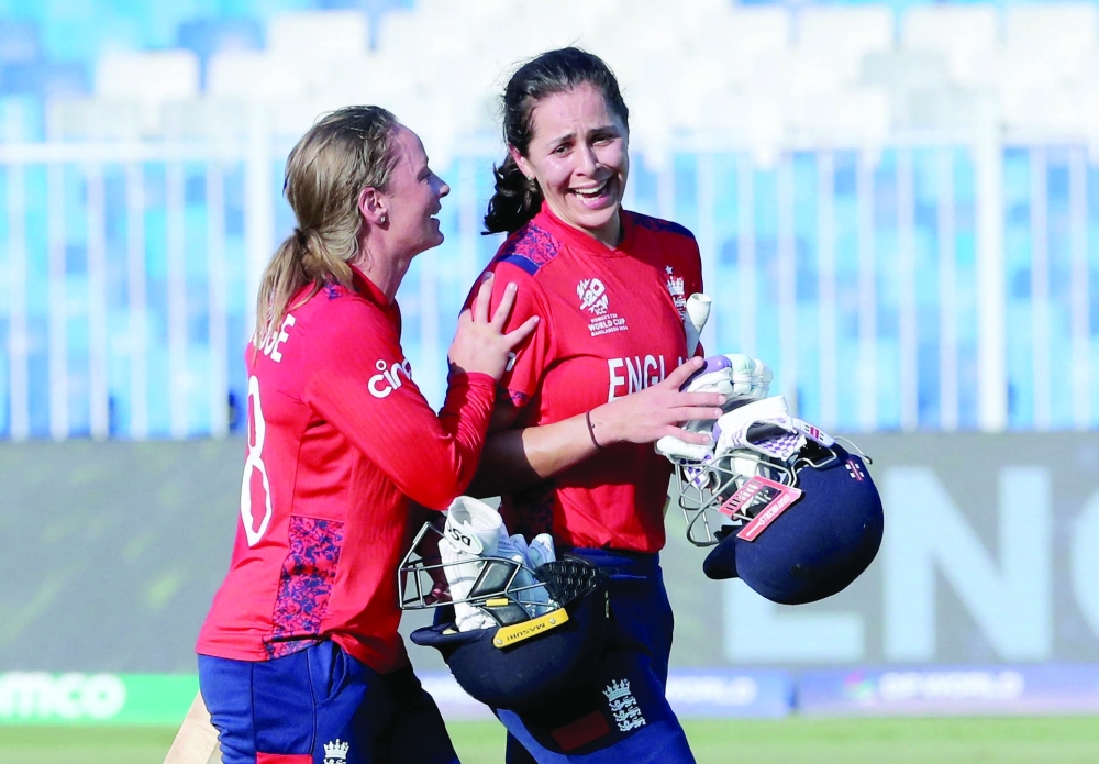 Cricket - Women's Cricket T20 World Cup - England v Scotland - Sharjah Cricket Stadium, Sharjah, United Arab Emirates - October 13, 2024  England's Maia Bouchier and England's Danni Wyatt-Hodge celebrate after the match. — REUTERS