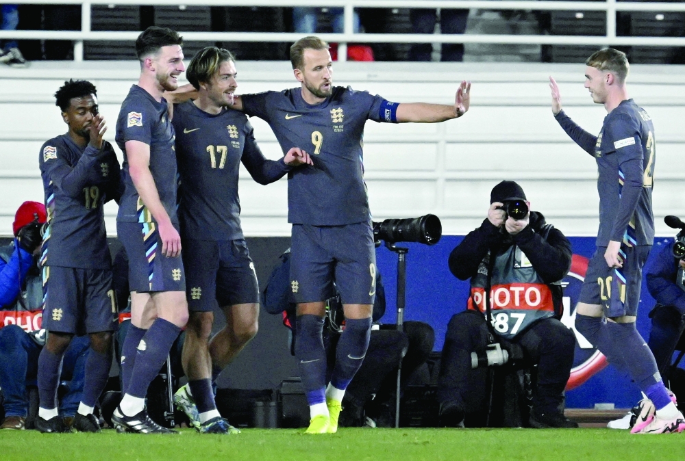 England's Jack Grealish celebrates scoring their first goal with teammates. — REUTERS