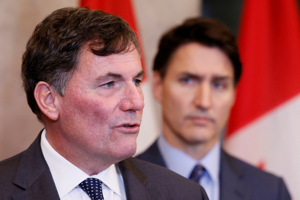 Canada's Minister of Public Safety, Democratic Institutions and Intergovernmental Affairs Dominic LeBlanc, with Canada's Prime Minister Justin Trudeau looking on, speaks during a press conference about the Royal Canadian Mounted Police's investigation into "violent criminal activity in Canada with connections to India
