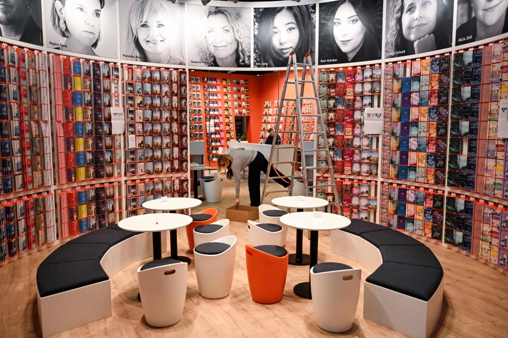 Employee prepares a booth at the Frankfurt book fair  prior to the opening of the world's biggest book fair in Frankfurt am Main, Germany. — AFP