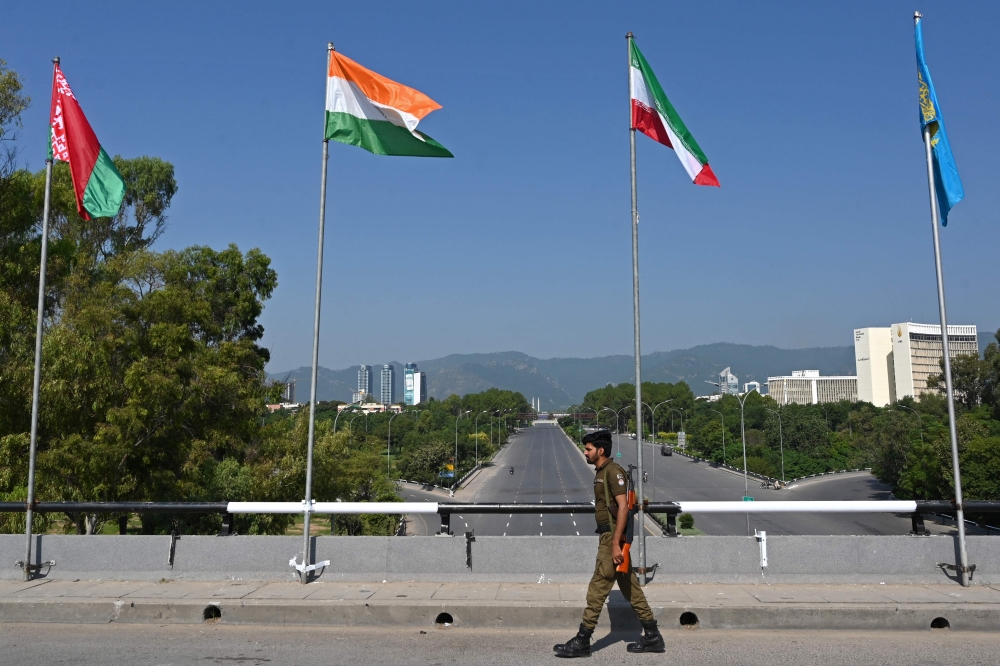 A policeman patrols near the venue of the Shanghai Cooperation Organisation (SCO) summit, in Islamabad. — AFP 
