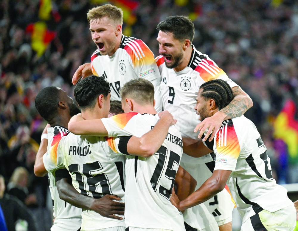 Germany's Jamie Leweling celebrates scoring their first goal with teammates.  REUTERS