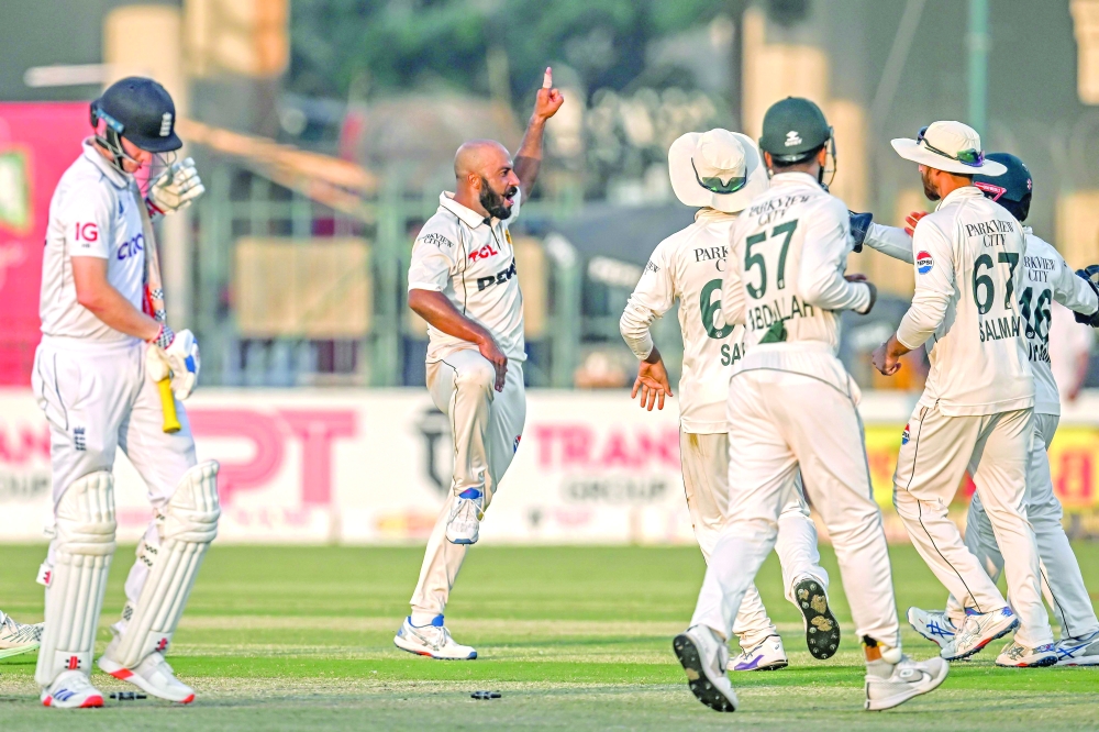 Pakistan's Sajid Khan (2L) celebrates with teammates after taking the wicket of England's Harry Brook (L) during the second day of the second Test cricket match between Pakistan and England at the Multan Cricket Stadium in Multan on October 16, 2024.